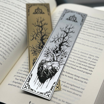 A heart with a tree growing out of it on metallic acrylic bookmarks.