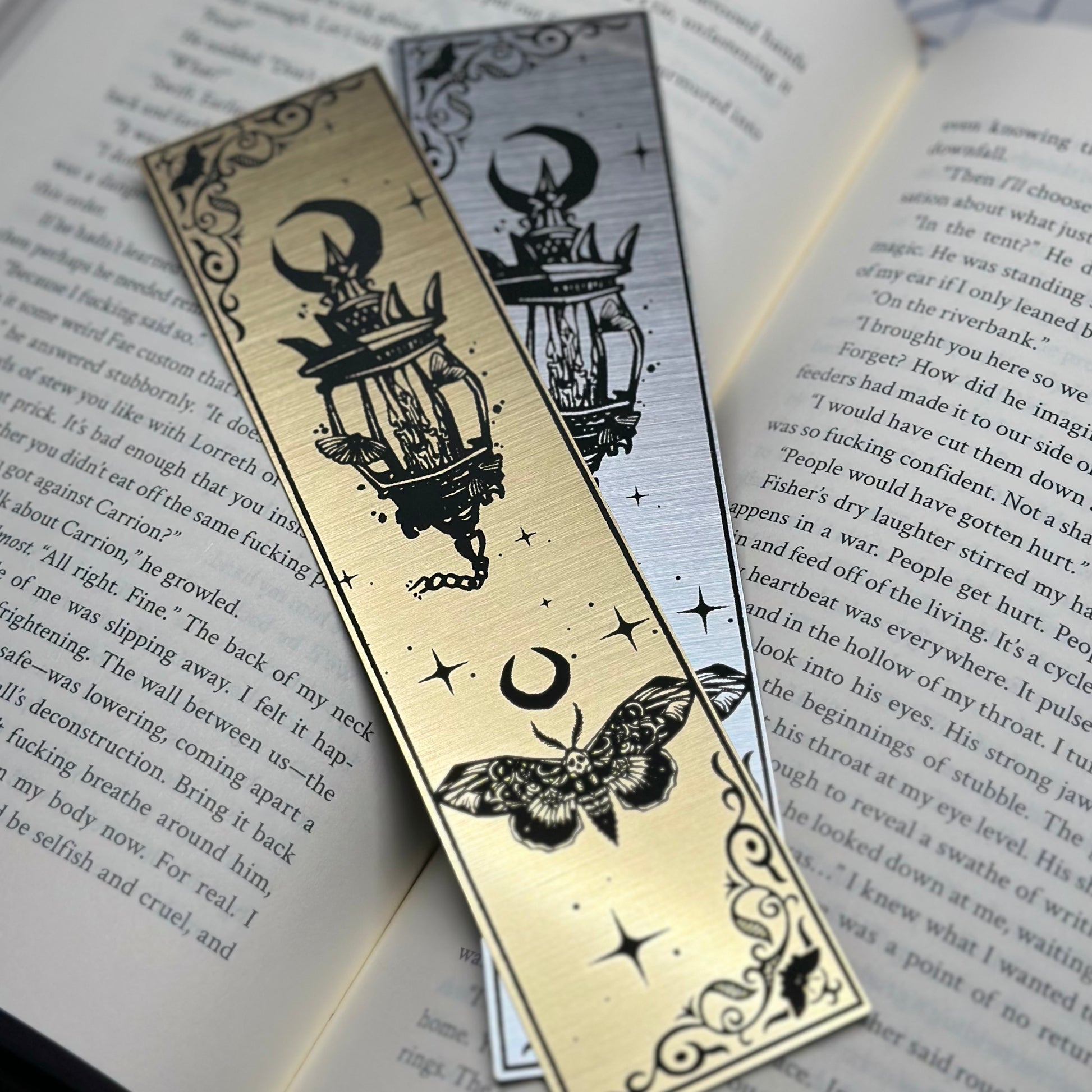 A lantern with a trio of moths on metallic acrylic bookmarks.