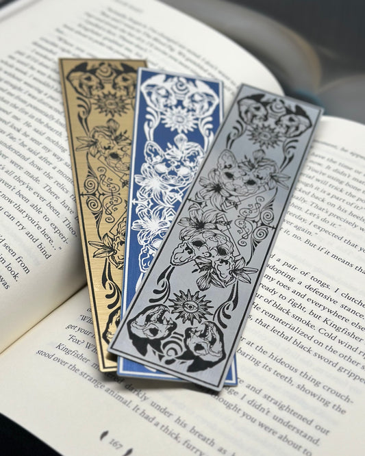 Three cat skull bookmarks etched on metallic acrylic