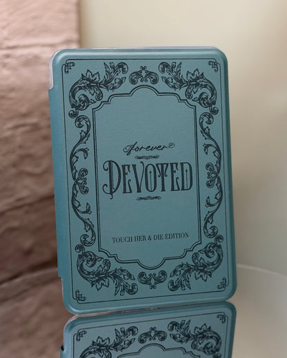 Kindle case with 'Forever Devoted' text and decorative elements on a reflective surface.