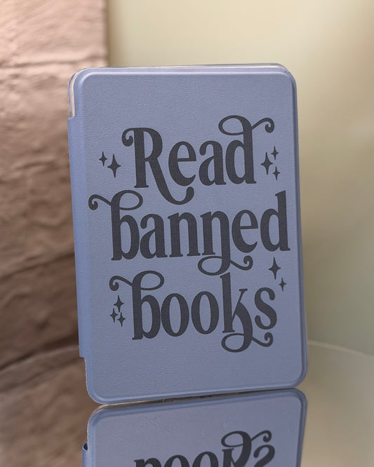 Dusty lavender kindle case with 'Read banned books' text on a reflective surface