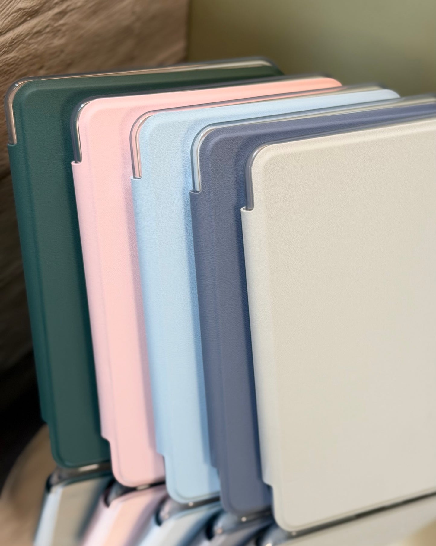 Stack of colorful Kindle cases on a reflective stand